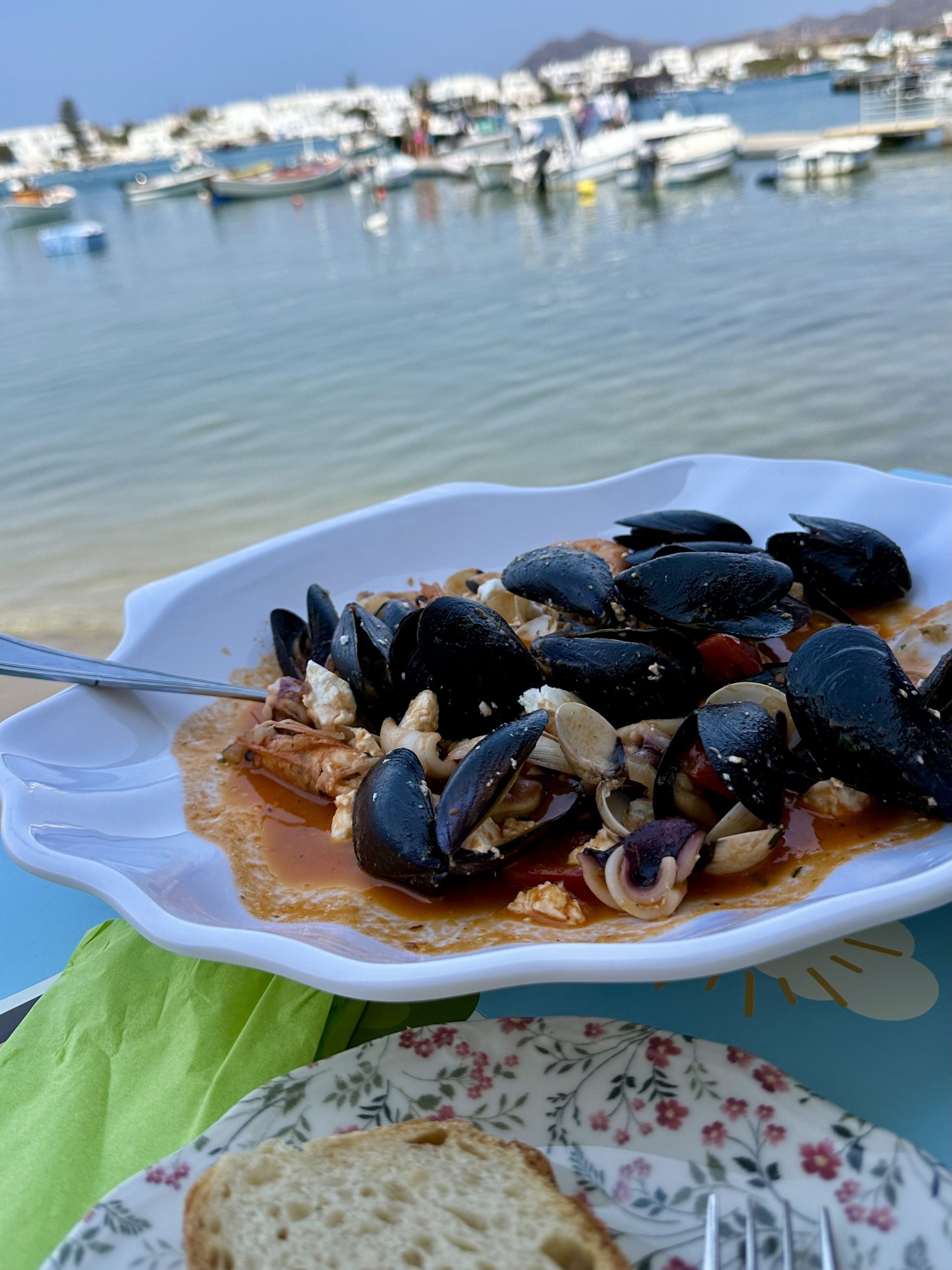 Seafood platter with mussels and calamari served at a seaside taverna in Milos, Greece.